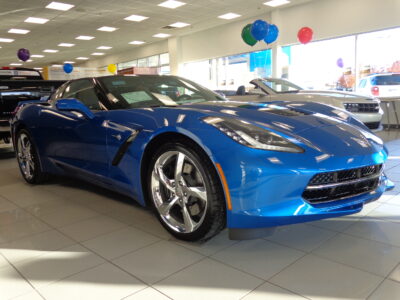 2014 Laguna Blue Chevy Corvette in a showroom