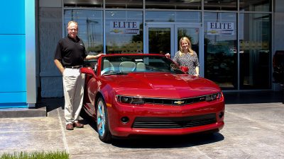 Pat and Lindsey McGrath with a red Chevy Camaro