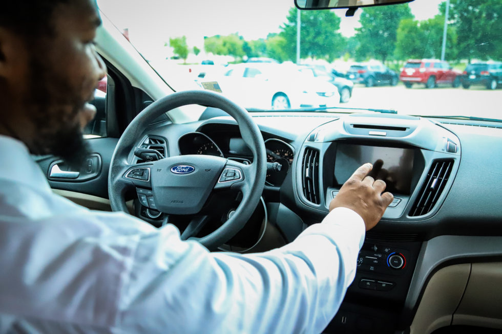 Man using Ford interior touch screen